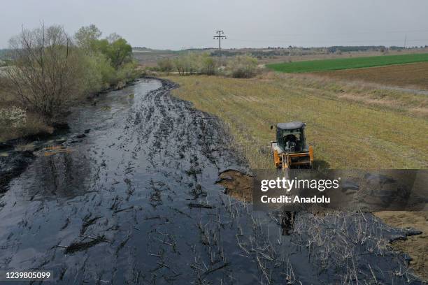 General view of the pitch leaked area from the pool at asphalt construction site during the cleaning works in Edirne, Turkiye on April 7, 2022.