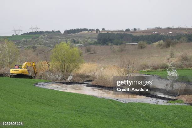 General view of the pitch leaked area from the pool at asphalt construction site during the cleaning works in Edirne, Turkiye on April 7, 2022.