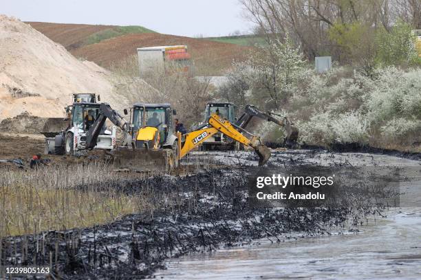 General view of the pitch leaked area from the pool at asphalt construction site during the cleaning works in Edirne, Turkiye on April 7, 2022.