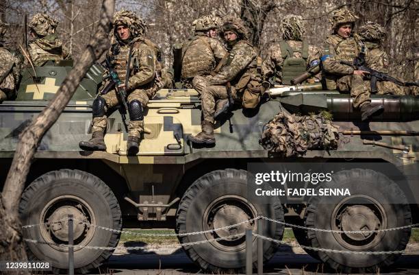 Ukrainian soldiers sit on a armoured military vehicule in the city of Severodonetsk, Donbas region, on April 7 amid Russia's military invasion...