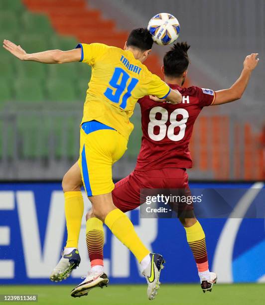 Foolad's midfielder Arash Rezavand and al-Gharafa's defender Mehdi Jean-Tahrat vie for a header during the AFC Champions League group C match between...