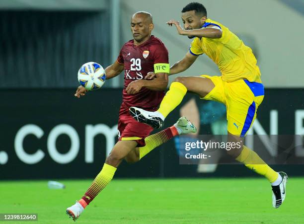 Al-Gharafa's forward Almahdi Ali Mukhtar marks Foolad's forward Luciano Mendes during the AFC Champions League group C match between Iran's Foolad...