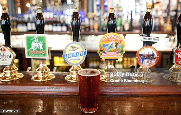 Pint of Jongleurs bitter sits on the bar at The Knights Templar public house, operated by JD Wetherspoon Plc, in London, U.K., on Wednesday, Sept. 7,...