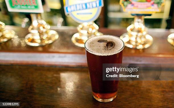 Pint of Jongleurs bitter sits on the bar at The Knights Templar public house, operated by JD Wetherspoon Plc, in London, U.K., on Wednesday, Sept. 7,...