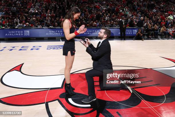 Ransom Hatch proposes to Julia Pontarelli during the game between the Boston Celtics and the Chicago Bulls on April 6, 2022 at United Center in...