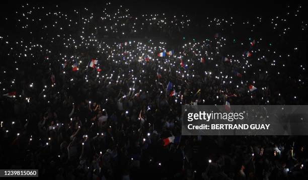 Media pundit and "Reconquete" party presidential candidate Eric Zemmour's supporters hold French flags and lit phones in the dark prior to Eric...