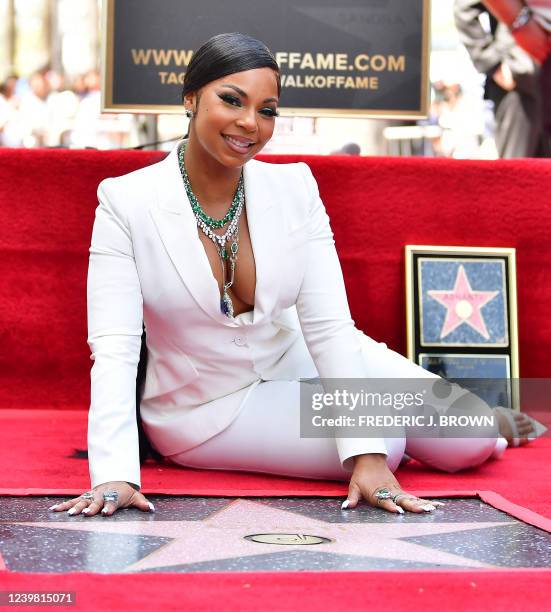 Recording artist Ashanti poses on her Hollywood Walk of Fame Star at a ceremony where she received the 2,718th Star in the category of Recording in...