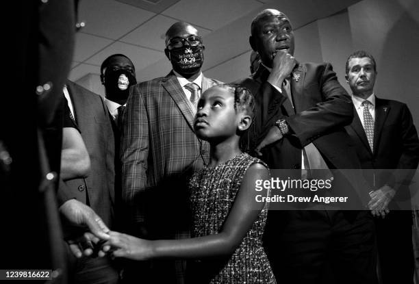 Gianna Floyd; daughter of George Floyd, looks on as Philonise Floyd, George Floyd's brother, and Attorney Ben Crump speak to reporters after a...