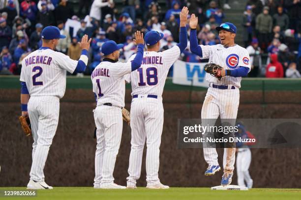 Seiya Suzuki of the Chicago Cubs hi-fives teammates after the Cubs win the game 5-4 over the Brewers during the game between the Milwaukee Brewers...