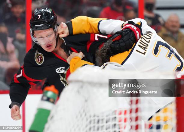 Brady Tkachuk of the Ottawa Senators fights with Jeremy Lauzon of the Nashville Predators at Canadian Tire Centre on April 7, 2022 in Ottawa,...