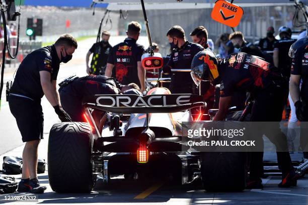 Red Bull's Dutch driver Max Verstappen gets ready to leave after a pit stop during the first practice session ahead of the 2022 Formula One...