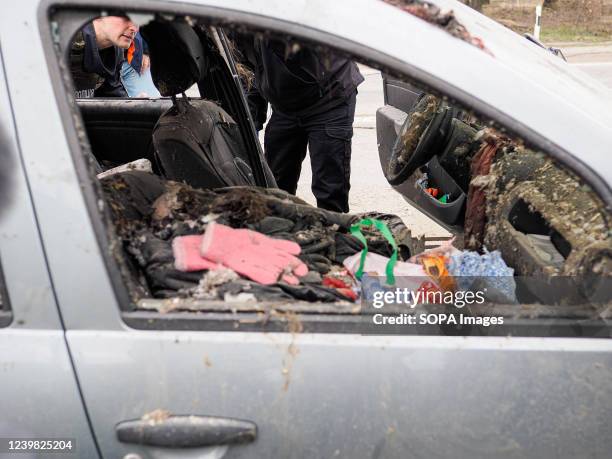 The dead body of a woman was killed allegedly by Russian troops while trying to escape from Bucha in a car with a white strip of cloth as a symbol of...