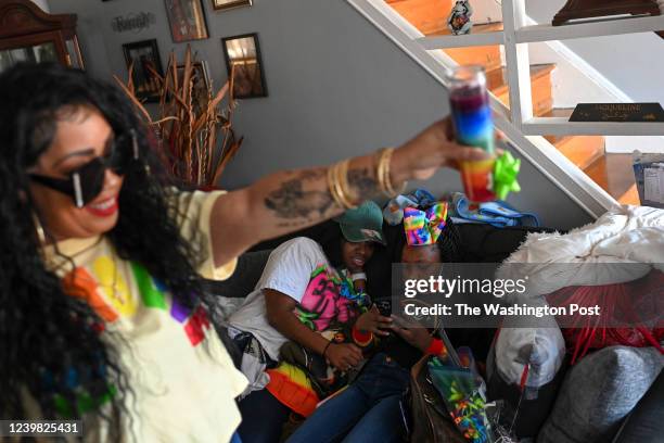 Kaleigh Washington sits with her mothers girlfriend Jameta Rooths at her great grandmothers house as her aunt Vernel Rogers holds a candle a before a...