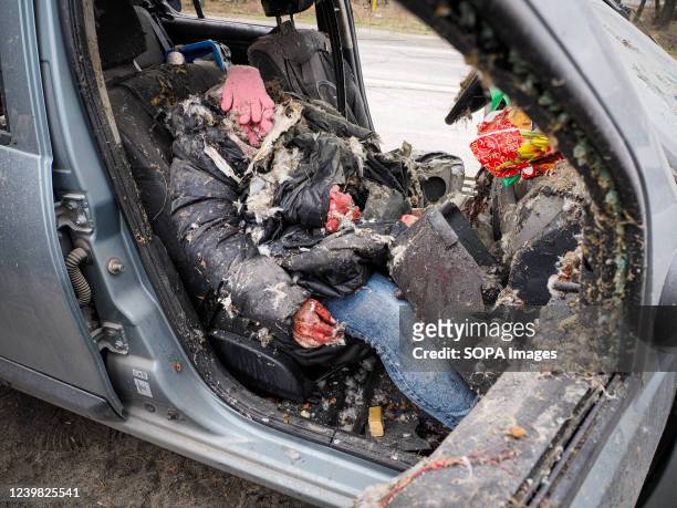 The dead body of a woman was killed allegedly by Russian troops while trying to escape from Bucha in a car with a white strip of cloth as a symbol of...