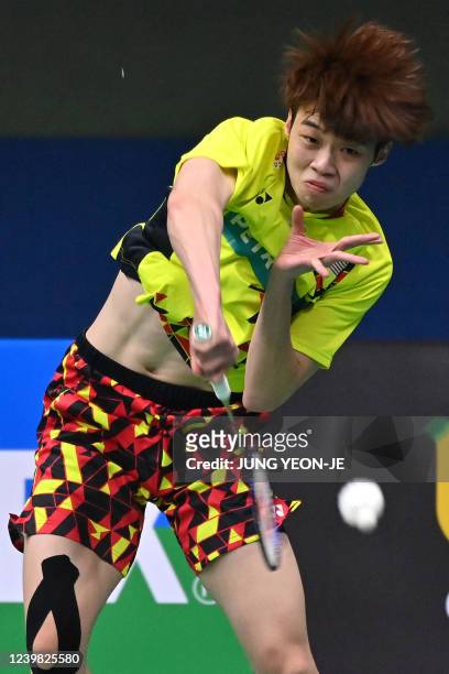 Malaysia's Ng Tze Yong hits a return against China's Weng Hongyang during their men's singles quarter-final match at the Korea Open Badminton...