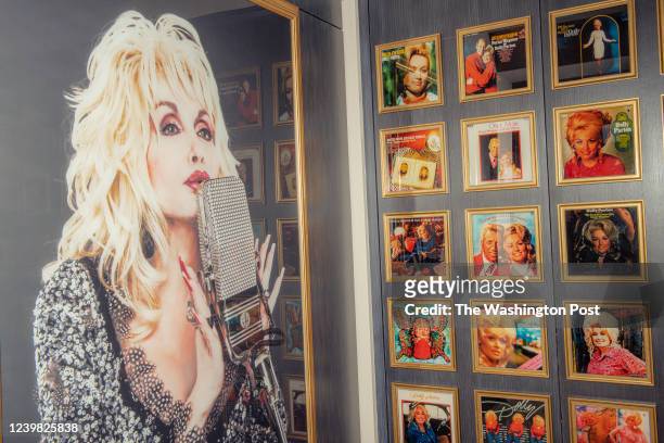 Album covers and a photograph of Dolly Parton are displayed at Dollywood's DreamMore Resort and Spa in Pigeon Forge, Tennessee on Friday, March 11,...