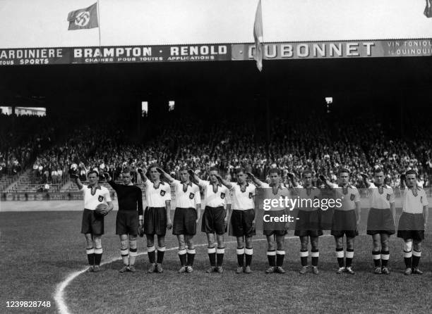 German national soccer team players execute the nazi salute, 04 June 1938 at the Parc des Princes stadium in Paris, before the start of their World...