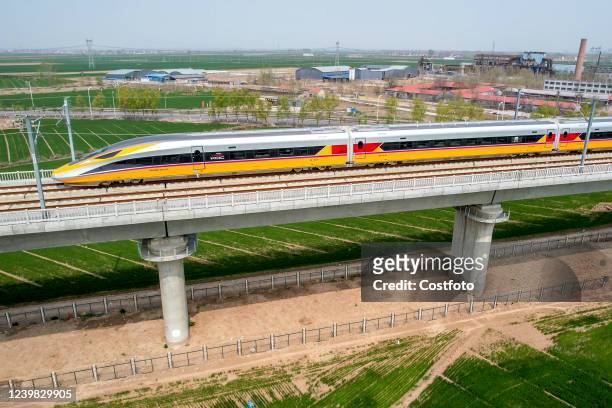 Aerial photo show a high-speed railway comprehensive inspection train, which will be exported to Indonesia, passes by on the Jinan-Zhengzhou...