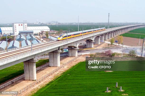 Aerial photo show a high-speed railway comprehensive inspection train, which will be exported to Indonesia, passes by on the Jinan-Zhengzhou...