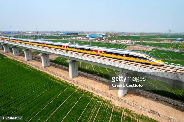 Aerial photo show a high-speed railway comprehensive inspection train, which will be exported to Indonesia, passes by on the Jinan-Zhengzhou...