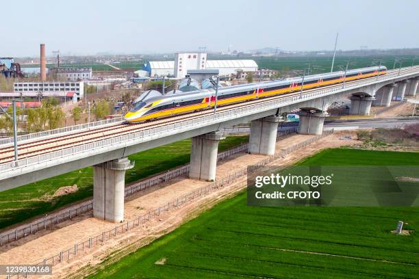 Aerial photo show a high-speed railway comprehensive inspection train, which will be exported to Indonesia, passes by on the Jinan-Zhengzhou...