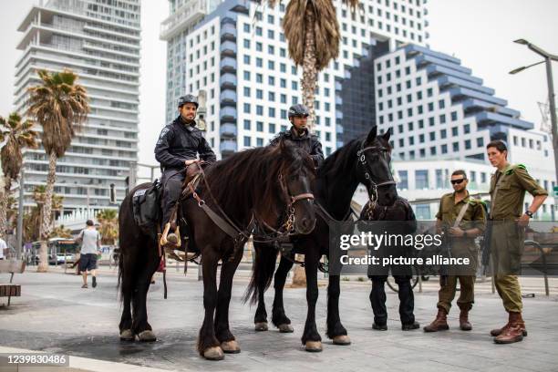 April 2022, Israel, Tel Aviv: Mounted Israeli policemen patrol the Tel Aviv promenade. Israel is in a state of high alert following a wave of terror...