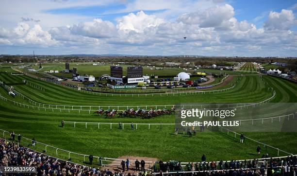 Runners and riders take part in the first race, the 20 Years Together, Alder Hey & Aintree Handicap Hurdle, on the second day of the Grand National...