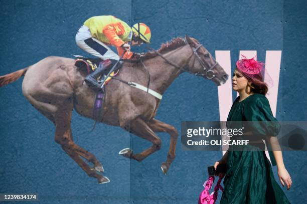 Racegoer attends the "Ladies day" on the second day of the Grand National Festival horse race meeting, at Aintree Racecourse, in Liverpool, north...