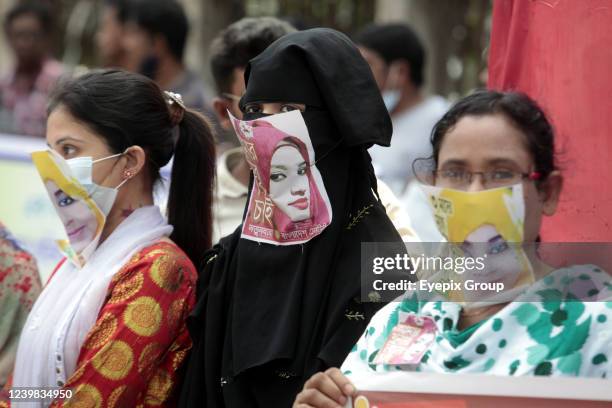Women wearing masks depicting Sohagi Jahan Tonu and Nusrat Jahan Rafi, victims of gender violence, take part in a demonstration to demand justice, in...