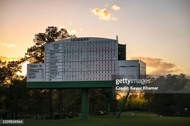 View of a leaderboard as the sun sets during the first round of the Masters at Augusta National Golf Club on April 7 in Augusta, Georgia.