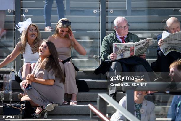 Racegoers attend the second day, "Ladies Day", of the Grand National Festival horse race meeting, at Aintree Racecourse, in Liverpool, north west...