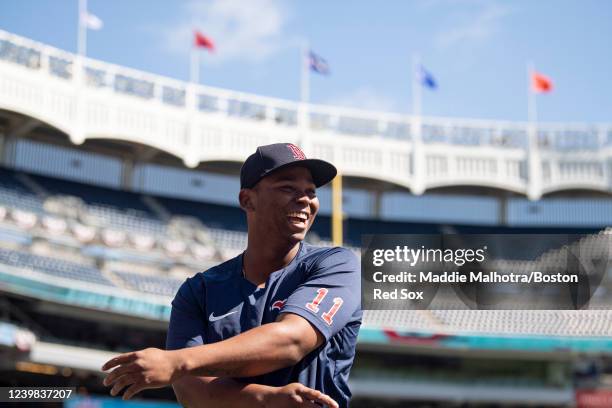 Rafael Devers of the Boston Red Sox laughs as he warms up before the 2022 Major League Baseball Opening Day game against the New York Yankees on...