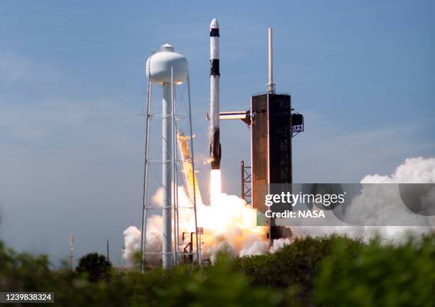 In this NASA handout, A SpaceX Falcon 9 rocket carrying the company's Crew Dragon spacecraft is launched on Axiom Mission 1 to the International...