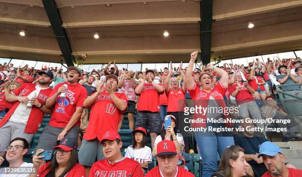Anaheim, CA Fans celebrate while the starting line up is announced as the Angels take on the Astros at Angel Stadium during opening day in Anaheim,...