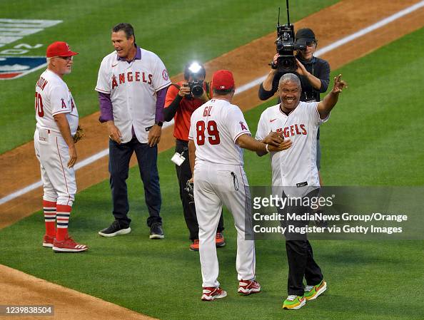 Benji Gil of the Anaheim Angels is congratulated by by third base News  Photo - Getty Images