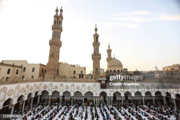 Muslims break their fast at the floor tables set in the mosque's courtyard during an iftar event held on the occasion of the Al-Azhar Mosque's 1082nd...