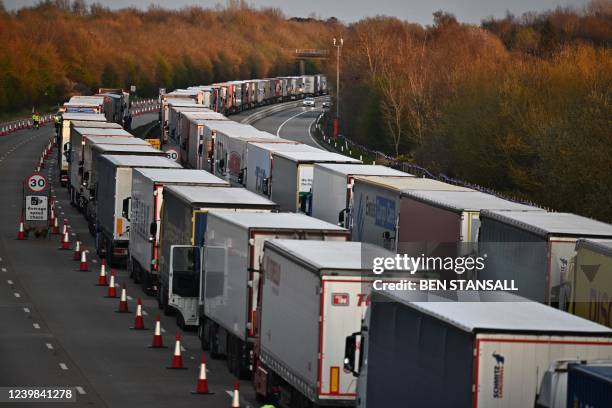 Freight lorries and HGVs queue on the M20 road near Lenham heading towards the port of Dover in the south-east of England on April 8, 2022.