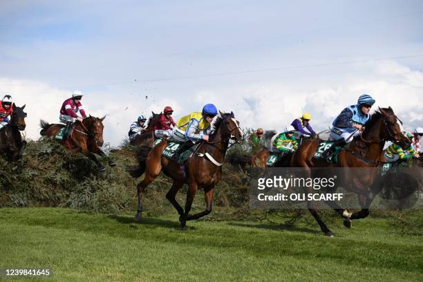 Horses and jockeys clear The Chair during the Randox Topham Handicap Steeple Chase on the second day of the Grand National Festival horse race...
