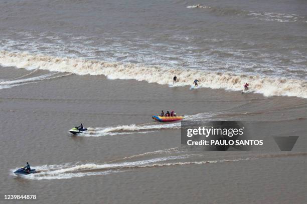 Aerial view of Brazilian surfers venturing into the waters of the mouth of the Amazon River, in an area known as Canal do Perigoso, to catch the...