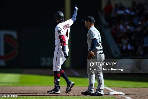 Carlos Correa of the Minnesota Twins celebrates a base hit while Ty France of the Seattle Mariners looks on in the first inning on Opening Day at...