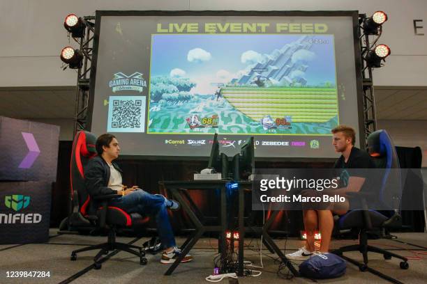 Gamers Unit21 and Safemoon play computer games at the Gaming Arena area during the Bitcoin 2022 Conference at Miami Beach Convention Center on April...