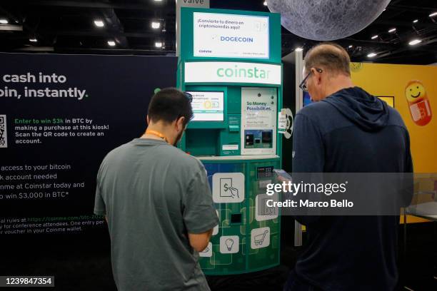 People buy bitcoins at a Coinstar ATM in the exhibition hall during the Bitcoin 2022 Conference at Miami Beach Convention Center on April 8, 2022 in...