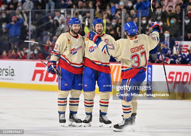 Cedric Paquette of the Laval Rocket celebrates his goal with teammates Xavier Ouellet and Brandon Gignac during the second period against the...