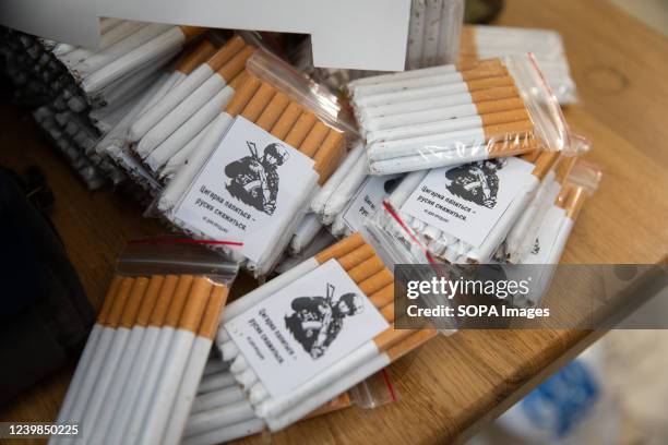 Cigarettes are packed by volunteers, as they will be delivered to the frontline for the Ukrainian soldiers. As the war progresses, citizens in Kyiv...