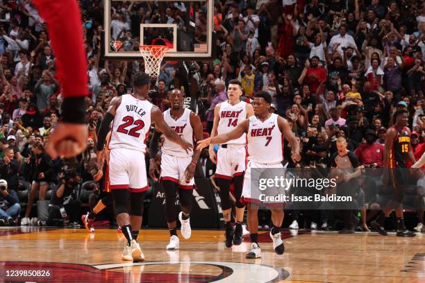 Jimmy Butler of the Miami Heat shakes hands with Kyle Lowry of the Miami Heat during the game against the Atlanta Hawks on April 8, 2022 at FTX Arena...