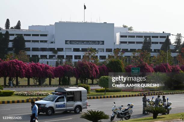 Security personnel patrol outside the Parliament House building in Islamabad on April 9, 2022. - Pakistan Prime Minister Imran Khan said he accepted...