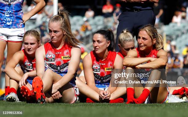 Eliza McNamara, Sinead Goldrick, Eden Zanker and Megan Fitzsimon of the Demons look dejected after a loss during the 2022 AFLW Grand Final match...