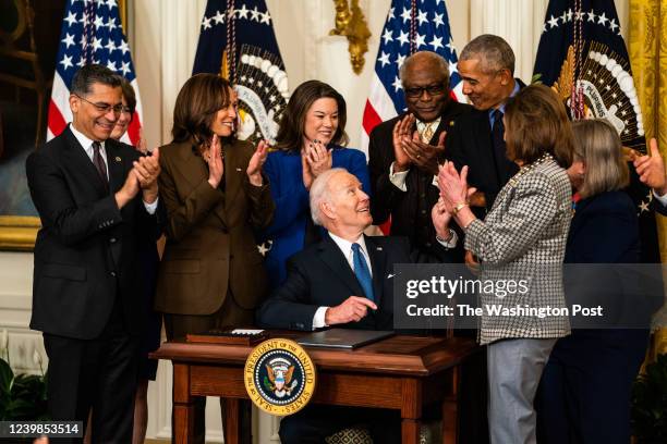 April 5, 2022: US President Joe Biden hands the pen used to sign an Executive Order to continue to strengthen access to the Affordable Care Act to...