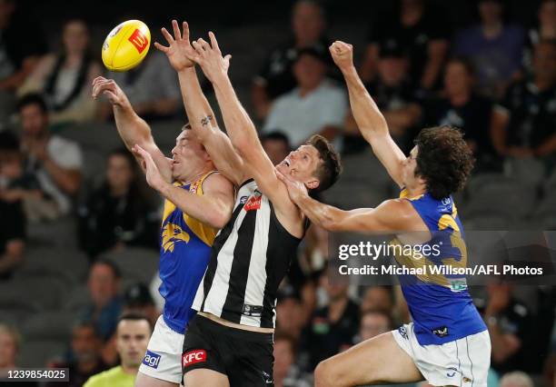 Jeremy McGovern of the Eagles, Brody Mihocek of the Magpies and Tom Barrass of the Eagles compete for the ball during the 2022 AFL Round 04 match...