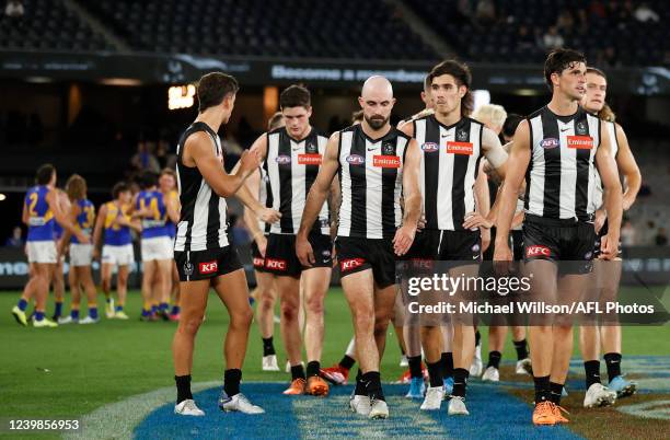 The Magpies look dejected after a loss during the 2022 AFL Round 04 match between the Collingwood Magpies and the West Coast Eagles at Marvel Stadium...